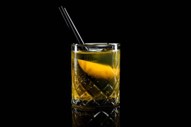 Cocktail Rusty Nail in a glass on a black background. High quality photo clipart