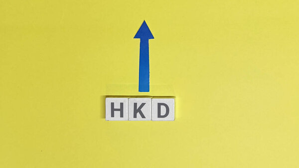 HKD currency is shown with an upward pointing arrow on a yellow background representing financial growth and investment potential suggesting a positive economic trend and increasing value in the mark