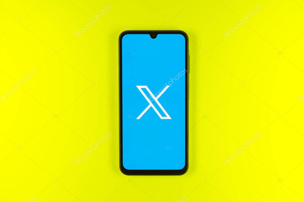 Prague, Czechia - 7 20 2024: Smartphone on surface showing social network X logo.