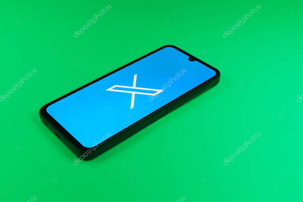 Prague, Czechia - 8 20 2024: Smartphone on surface showing social network X logo.