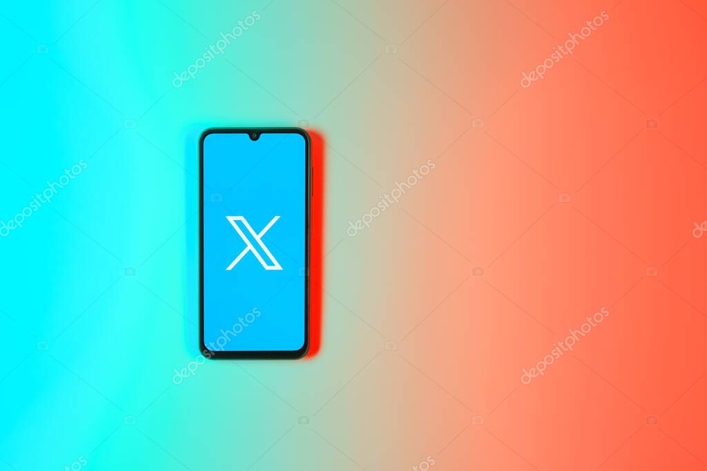 Prague, Czechia - 7 20 2024: Smartphone on surface showing social network X logo.