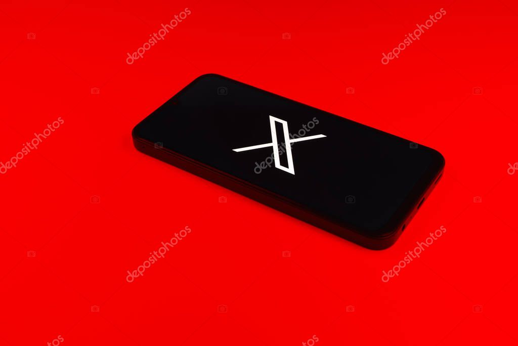 Prague, Czechia - 7 20 2024: Smartphone on surface showing social network X logo.
