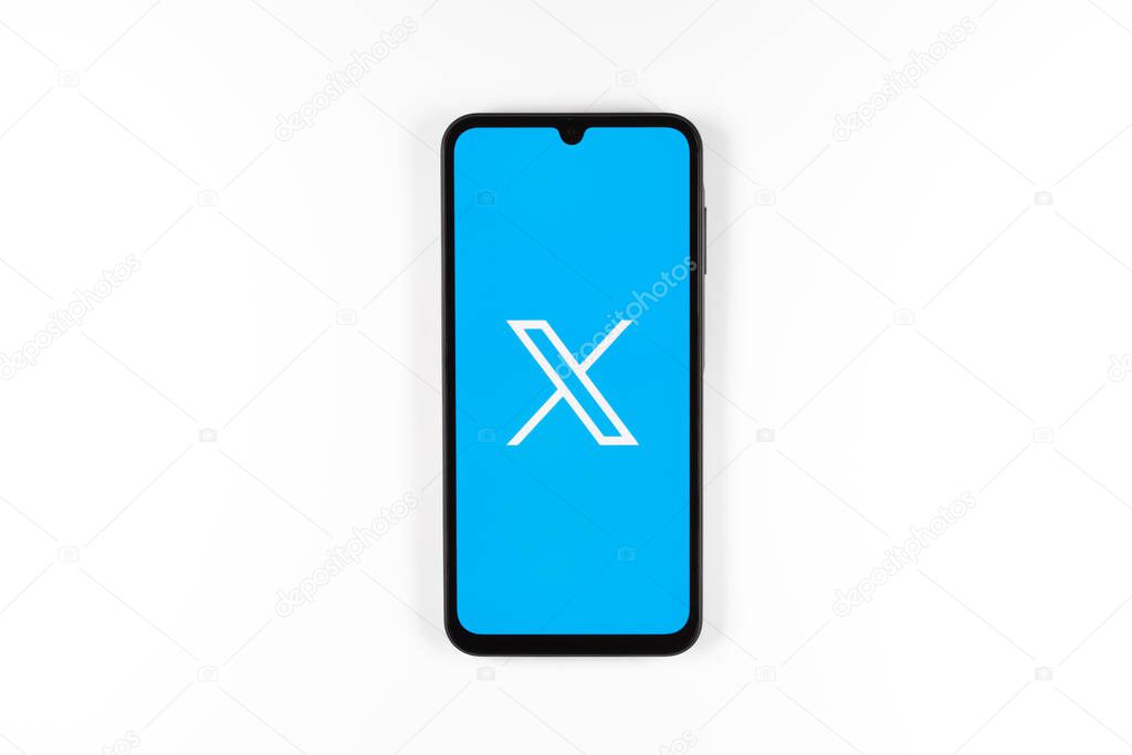 Prague, Czechia - 7 20 2024: Smartphone on surface showing social network X logo.