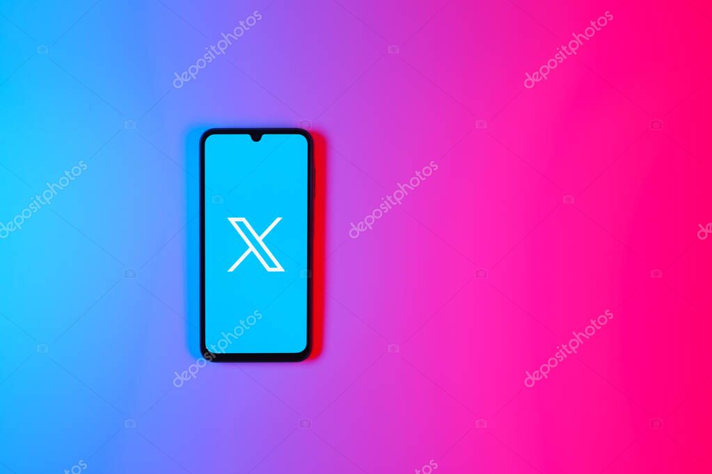 Prague, Czechia - 7 20 2024: Smartphone on surface showing social network X logo.