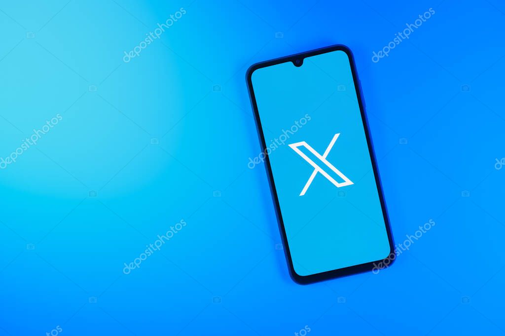 Prague, Czechia - 7 20 2024: Smartphone on surface showing social network X logo.