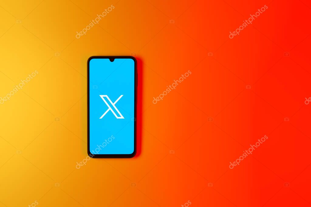 Prague, Czechia - 7 20 2024: Smartphone on surface showing social network X logo.