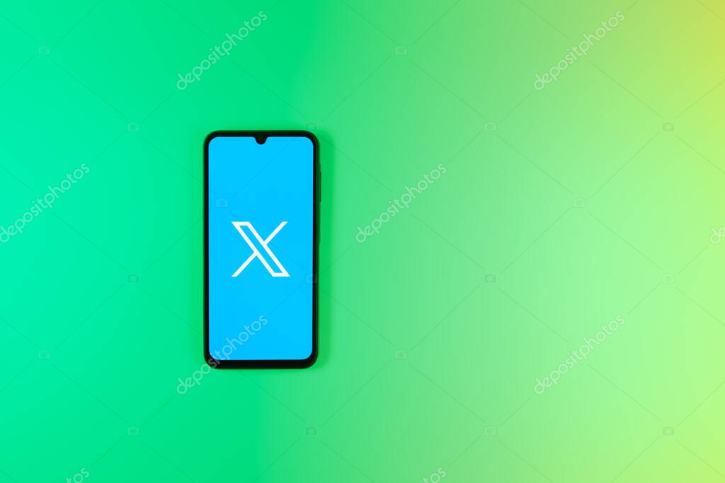 Prague, Czechia - 7 20 2024: Smartphone on surface showing social network X logo.