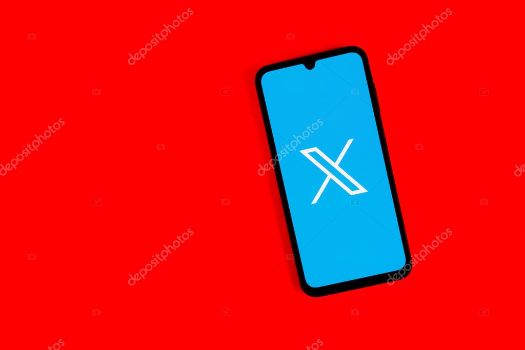 Prague, Czechia - 7 20 2024: Smartphone on surface showing social network X logo.
