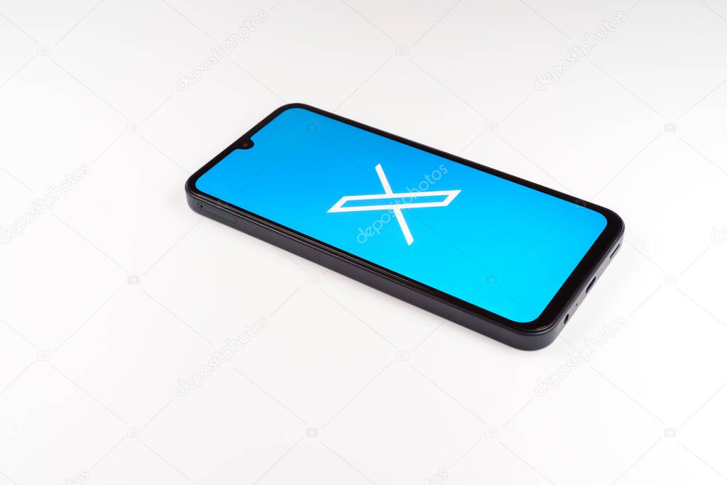 Prague, Czechia - 7 20 2024: Smartphone on surface showing social network X logo.