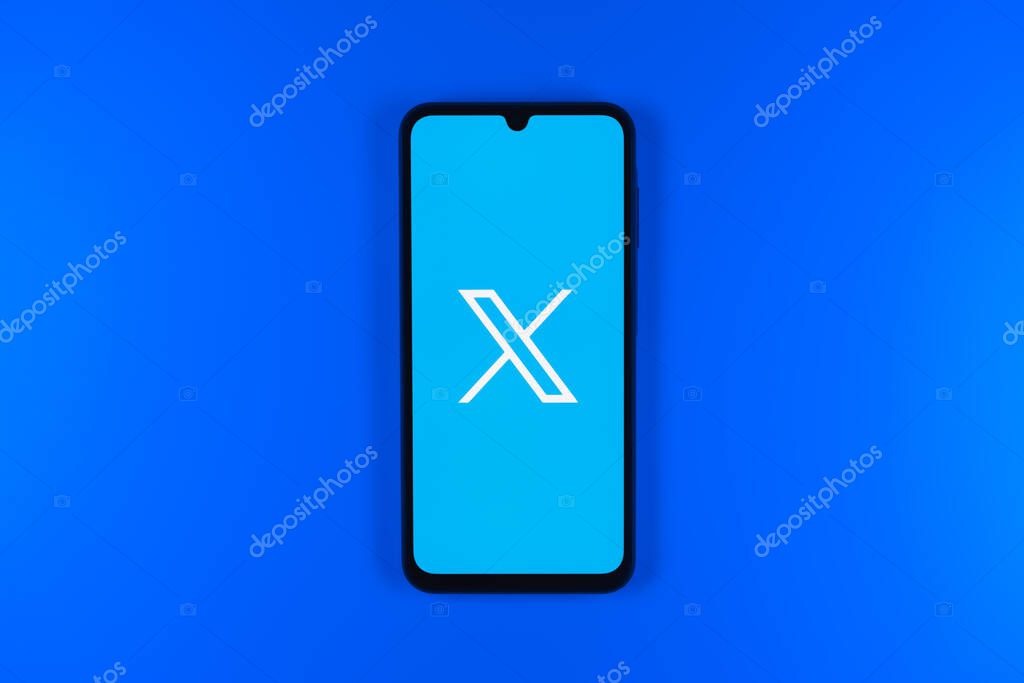 Prague, Czechia - 7 20 2024: Smartphone on surface showing social network X logo.