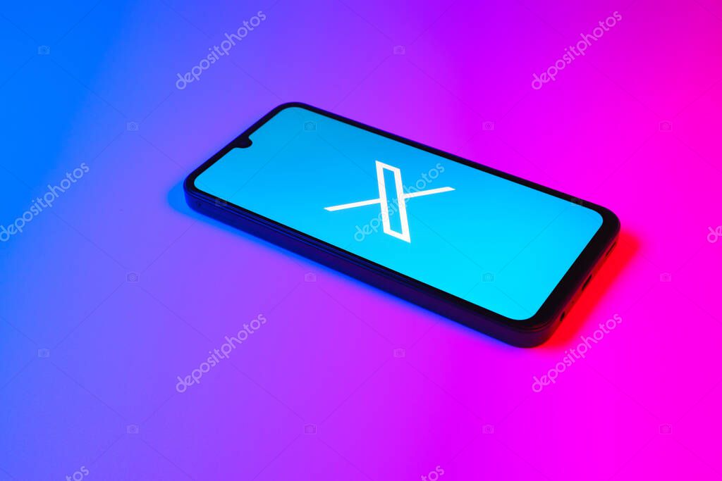 Prague, Czechia - 7 20 2024: Smartphone on surface showing social network X logo.
