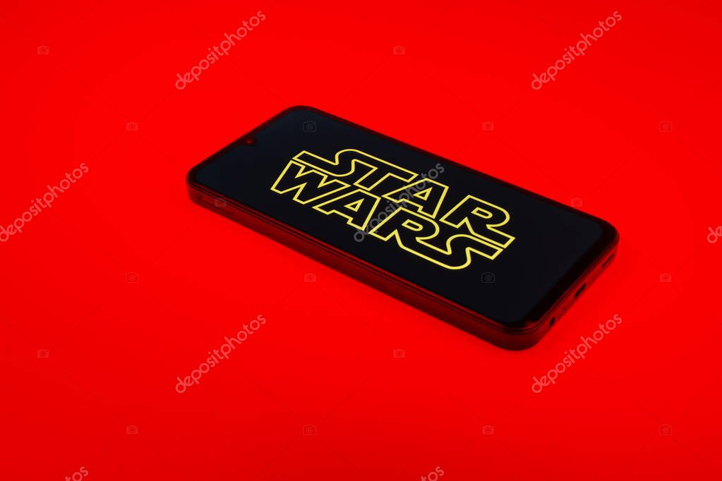 Prague, Czechia - 10 21 2024: Smartphone on surface showing Star Wars logo.