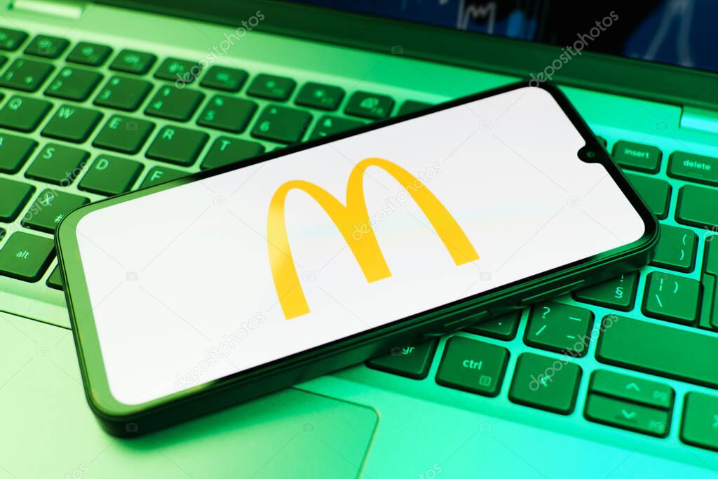 Prague, Czechia - 10 21 2024: Smartphone on surface showing McDonalds logo.