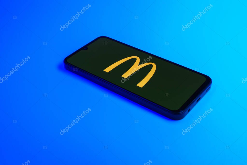 Prague, Czechia - 10 21 2024: Smartphone on surface showing McDonalds logo.
