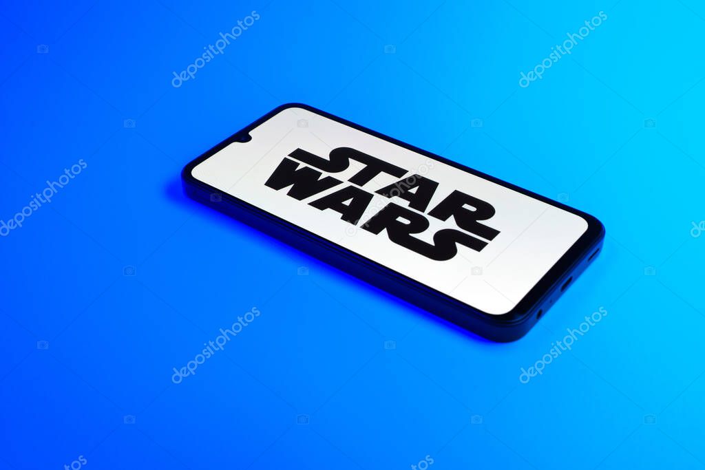 Prague, Czechia - 10 21 2024: Smartphone on surface showing Star Wars logo.