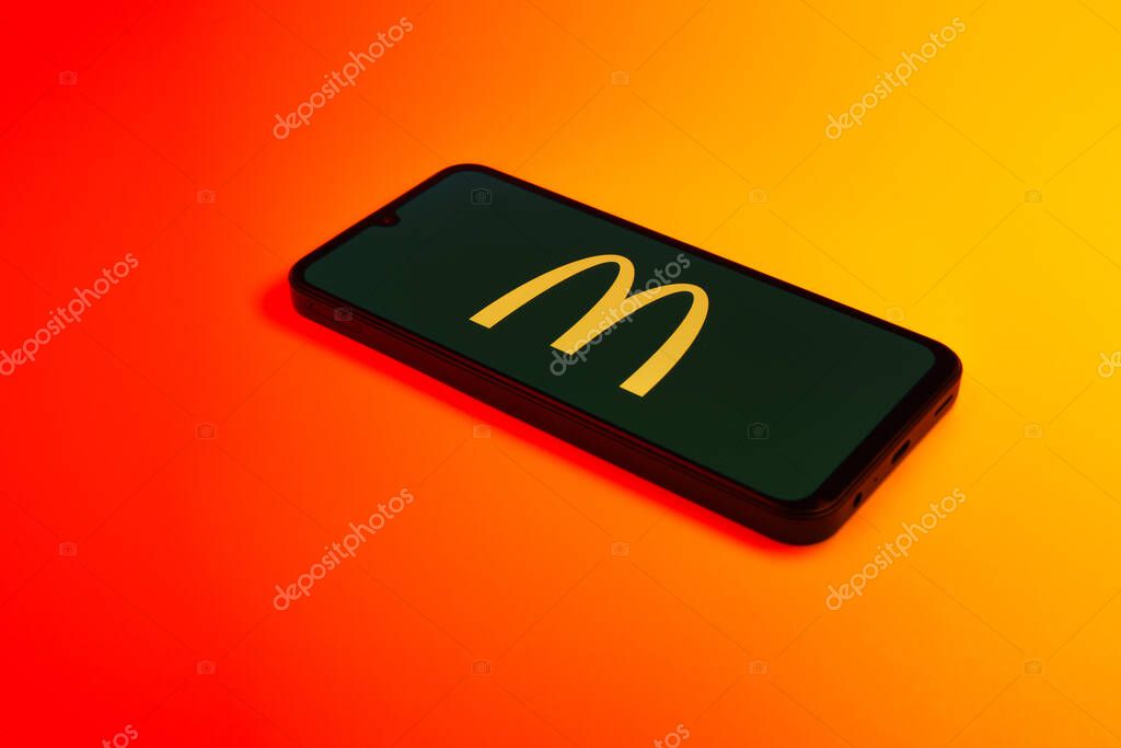Prague, Czechia - 10 21 2024: Smartphone on surface showing McDonalds logo.