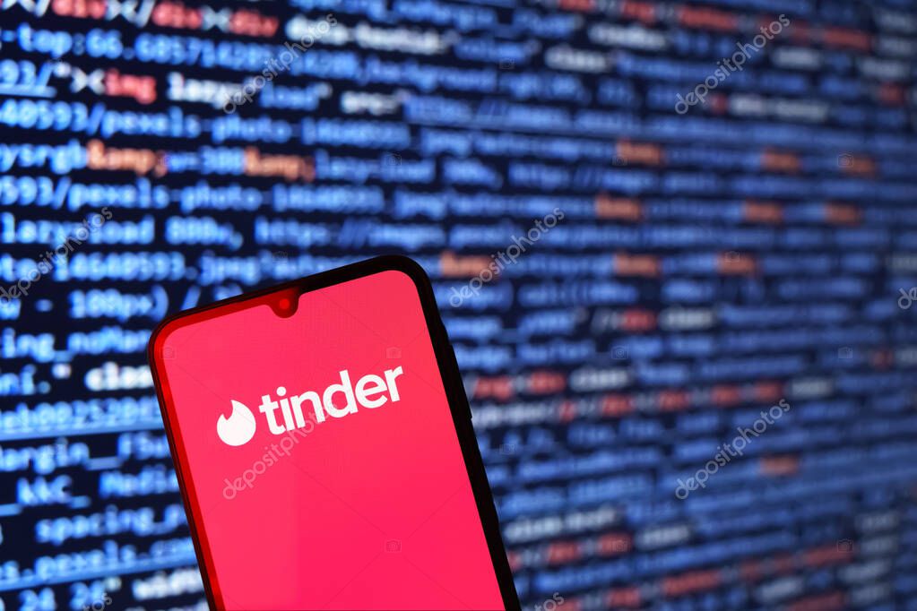 Prague, Czechia - 10 21 2024: Smartphone on surface showing Tinder logo.