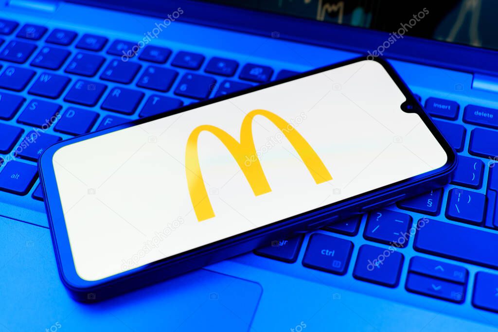 Prague, Czechia - 10 21 2024: Smartphone on surface showing McDonalds logo.
