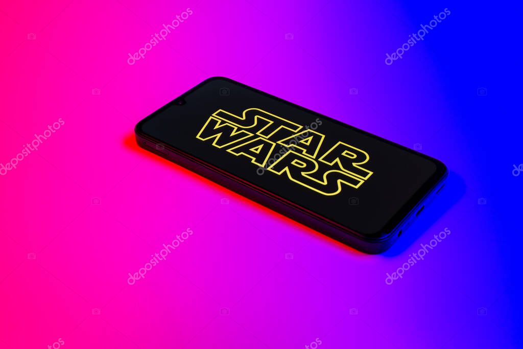 Prague, Czechia - 10 21 2024: Smartphone on surface showing Star Wars logo.