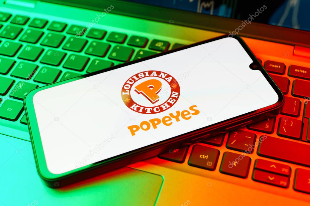 Prague, Czechia - 10 21 2024: Smartphone on surface showing Popeyes logo.