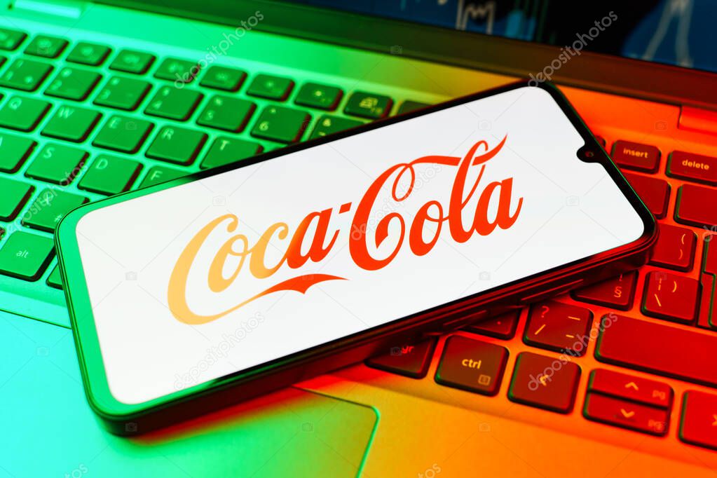 Prague, Czechia - 10 21 2024: Smartphone on surface showing Coca-Cola logo.