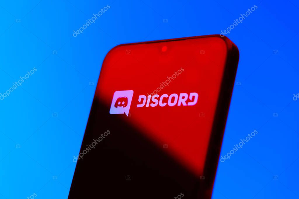 Prague, Czechia - 10 21 2024: Smartphone on surface showing Discord logo.