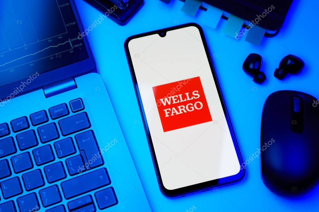 Prague, Czechia - 10 21 2024: Smartphone on surface showing Wells Fargo logo.
