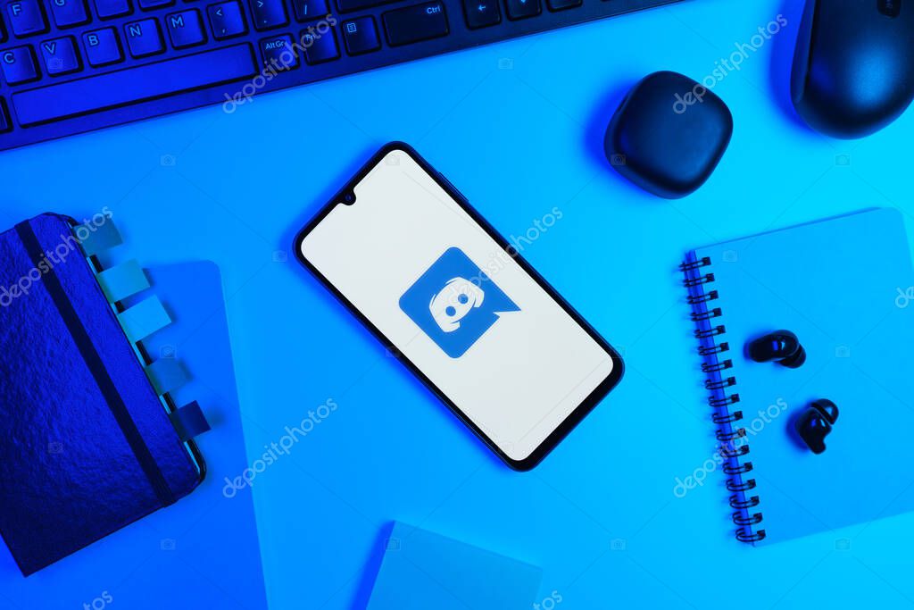 Prague, Czechia - 10 21 2024: Smartphone on surface showing Discord logo.