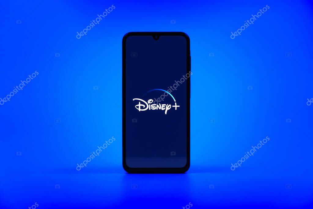Prague, Czechia - 10 21 2024: Smartphone on surface showing Disney + logo.