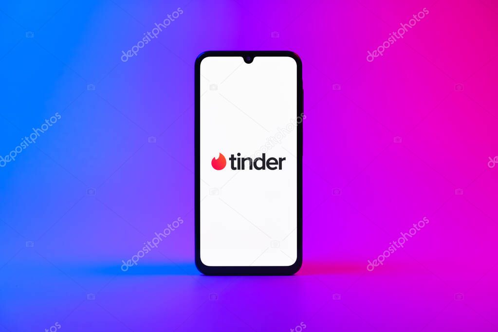 Prague, Czechia - 10 21 2024: Smartphone on surface showing Tinder logo.