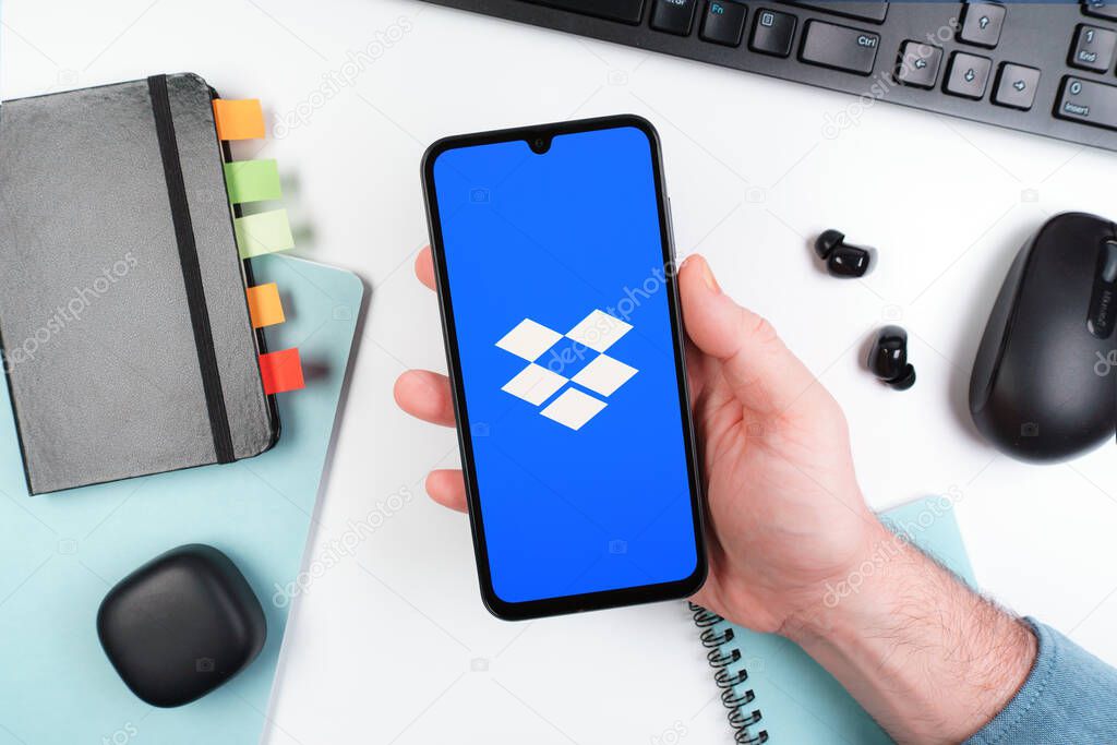Prague, Czechia - 10 21 2024: Smartphone on surface showing Dropbox logo.