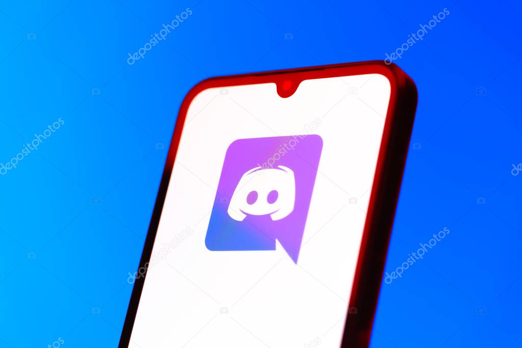 Prague, Czechia - 10 21 2024: Smartphone on surface showing Discord logo.
