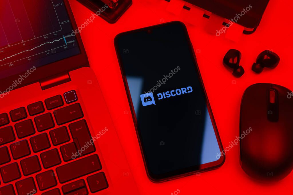 Prague, Czechia - 10 21 2024: Smartphone on surface showing Discord logo.