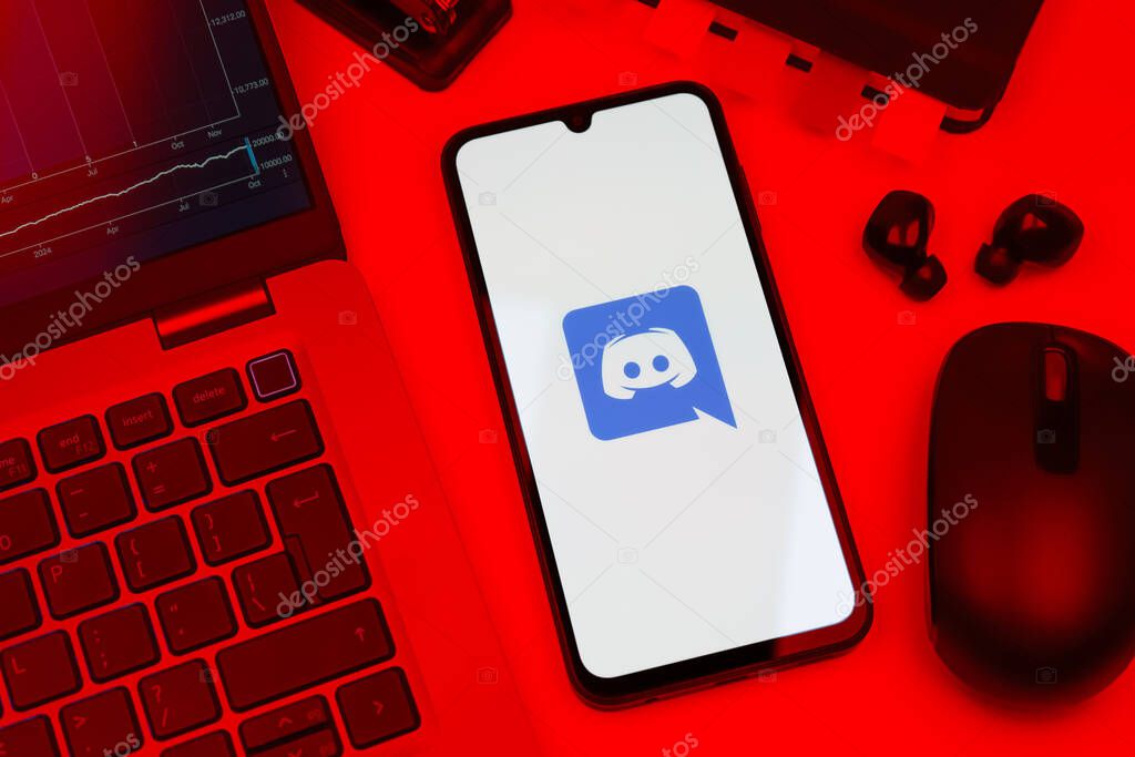 Prague, Czechia - 10 21 2024: Smartphone on surface showing Discord logo.
