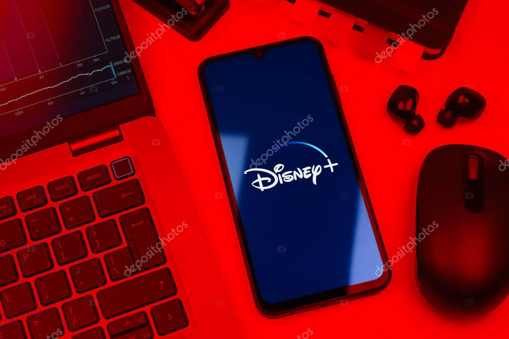 Prague, Czechia - 10 21 2024: Smartphone on surface showing Disney + logo.