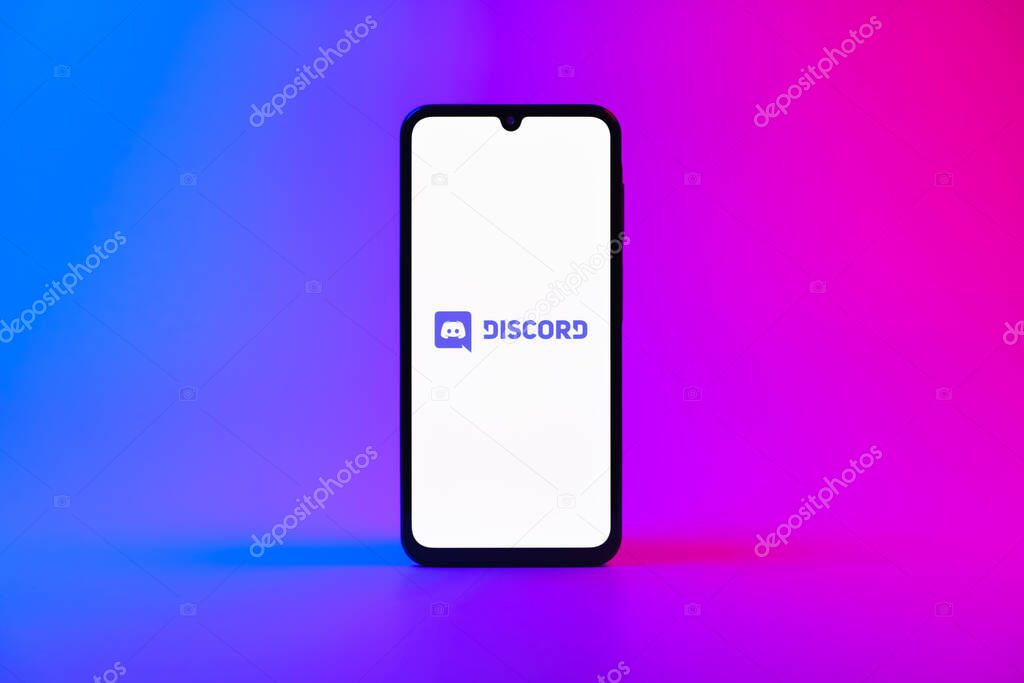 Prague, Czechia - 10 21 2024: Smartphone on surface showing Discord logo.