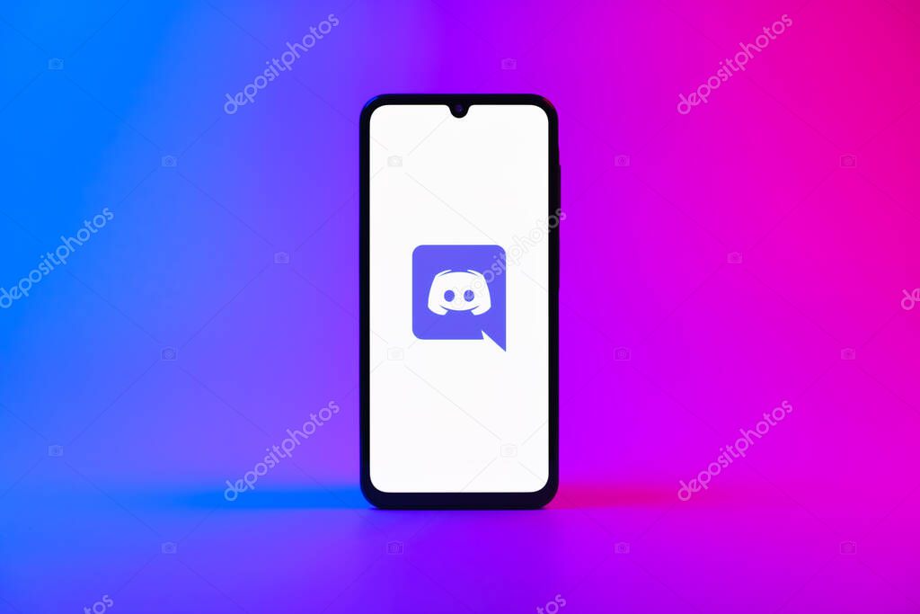 Prague, Czechia - 10 21 2024: Smartphone on surface showing Discord logo.