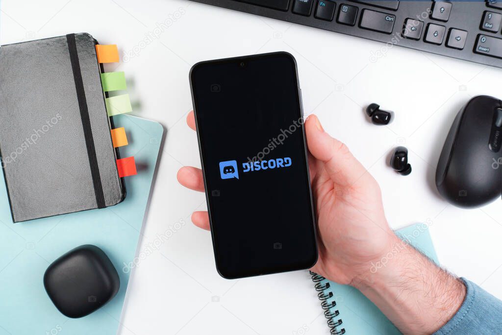 Prague, Czechia - 10 21 2024: Smartphone on surface showing Discord logo.