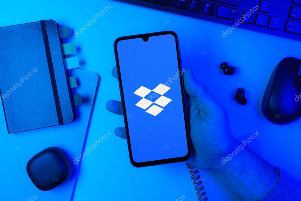 Prague, Czechia - 10 21 2024: Smartphone on surface showing Dropbox logo.