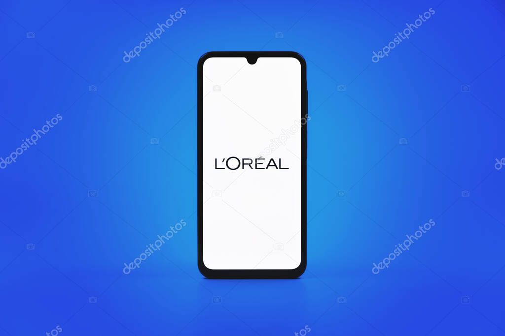 Prague, Czechia - 10 21 2024: Smartphone on surface showing L'Oreal logo.