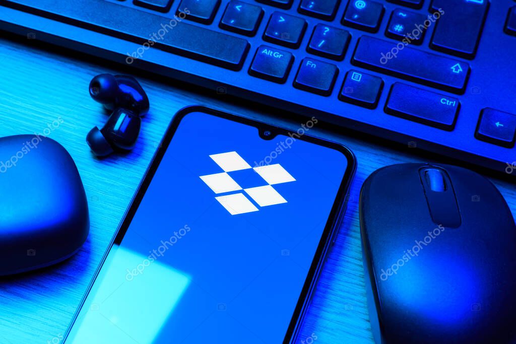 Prague, Czechia - 10 21 2024: Smartphone on surface showing Dropbox logo.