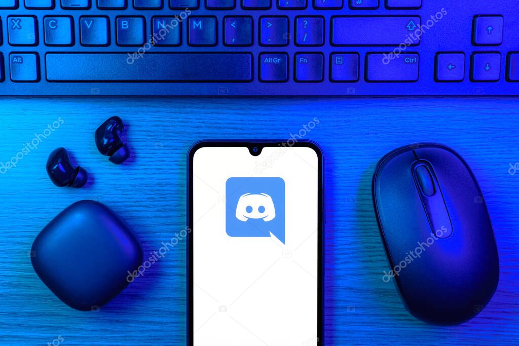 Prague, Czechia - 10 21 2024: Smartphone on surface showing Discord logo.