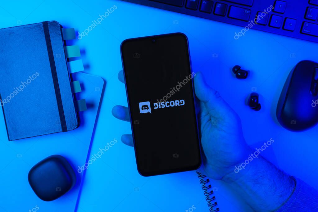Prague, Czechia - 10 21 2024: Smartphone on surface showing Discord logo.