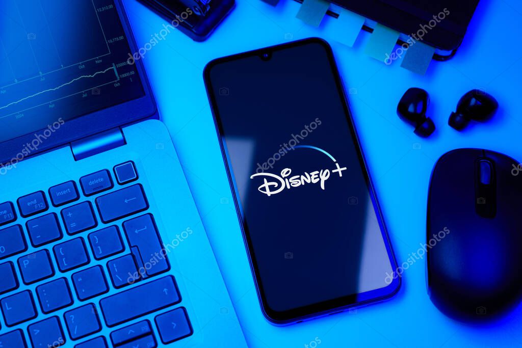 Prague, Czechia - 10 21 2024: Smartphone on surface showing Disney + logo.