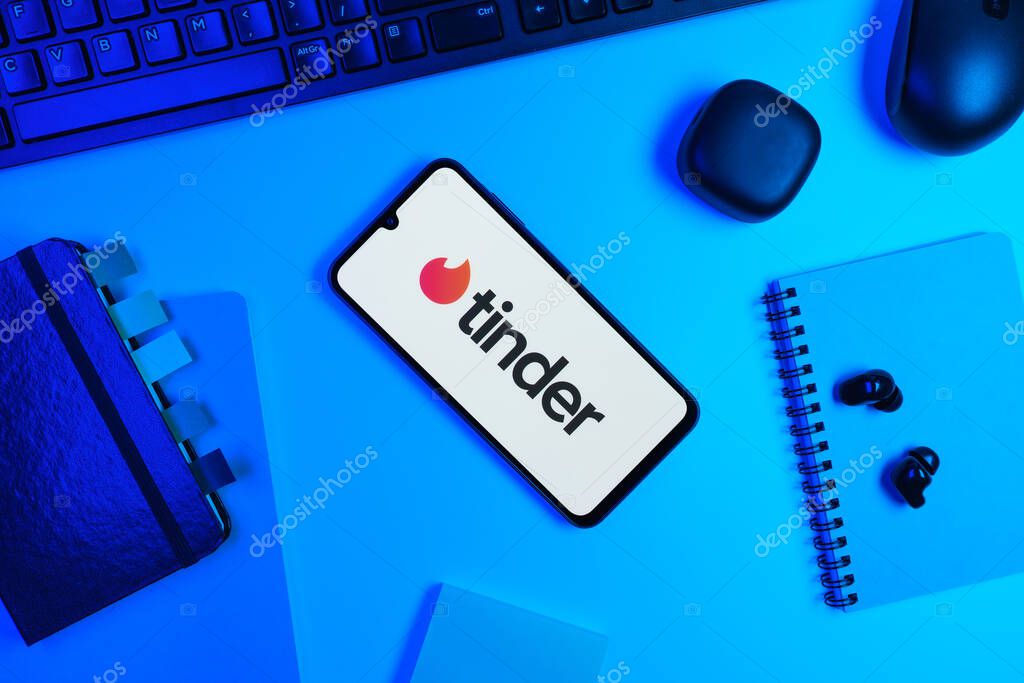 Prague, Czechia - 10 21 2024: Smartphone on surface showing Tinder logo.
