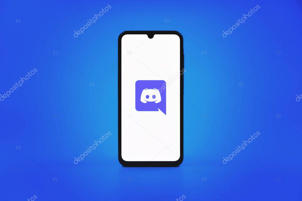Prague, Czechia - 10 21 2024: Smartphone on surface showing Discord logo.