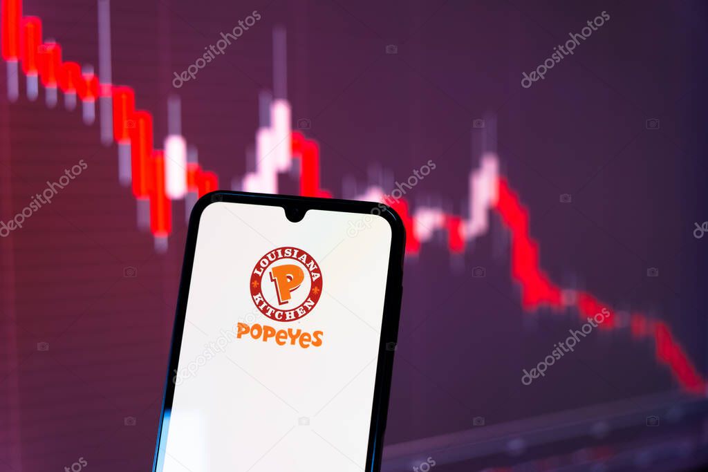 Prague, Czechia - 10 21 2024: Smartphone on surface showing Popeyes logo.