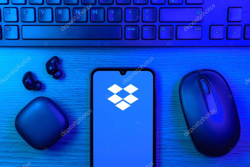 Prague, Czechia - 10 21 2024: Smartphone on surface showing Dropbox logo.
