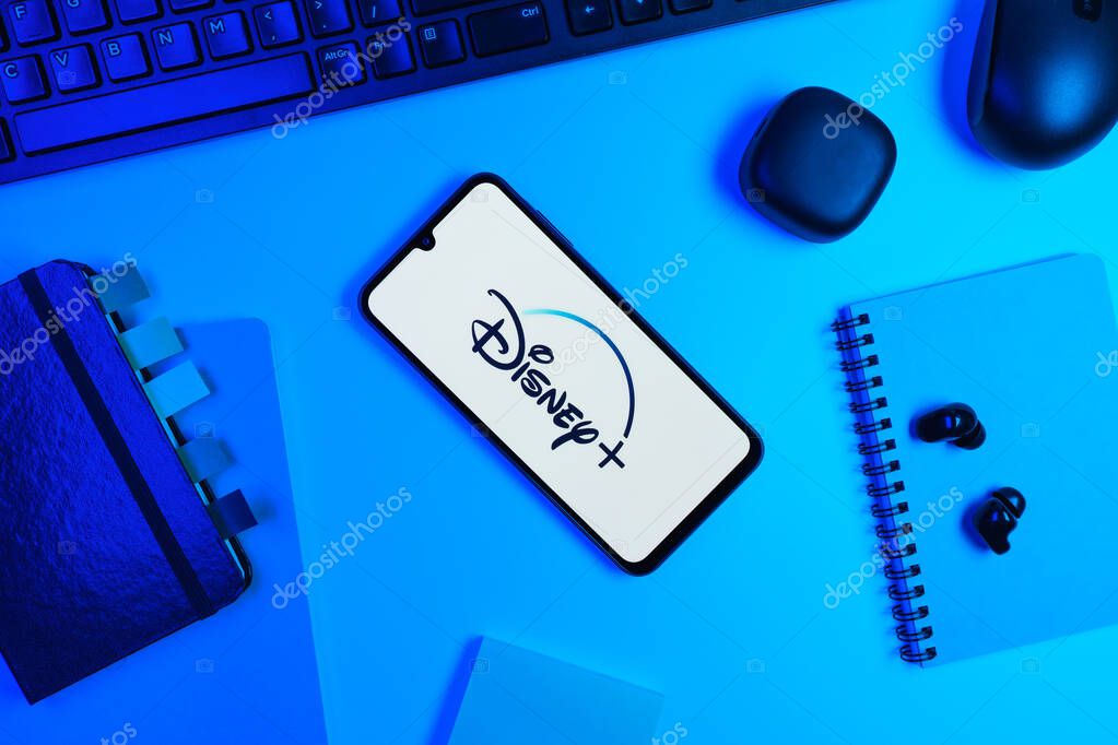 Prague, Czechia - 10 21 2024: Smartphone on surface showing Disney + logo.