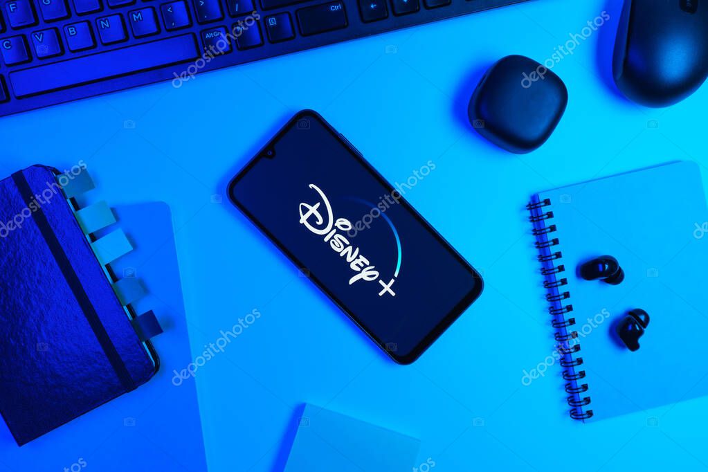 Prague, Czechia - 10 21 2024: Smartphone on surface showing Disney + logo.